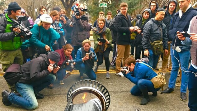 What Does It Say About the Media When They Flock to Photograph a Small Flame Contained within a Trash Can?